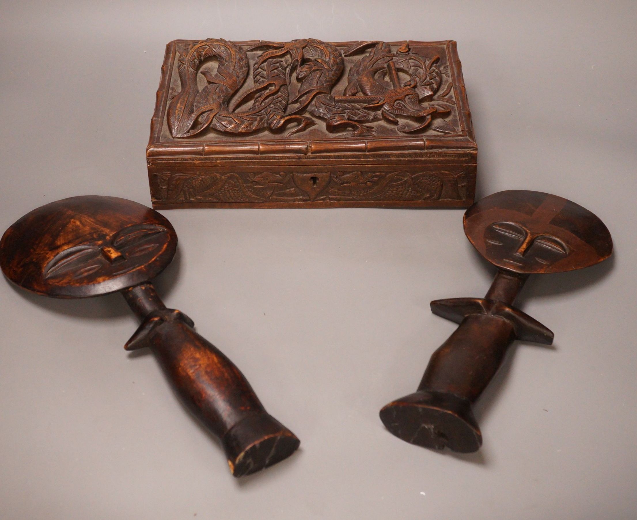 Two carved African wooden figures, together with a Burmese carved dragon wooden box